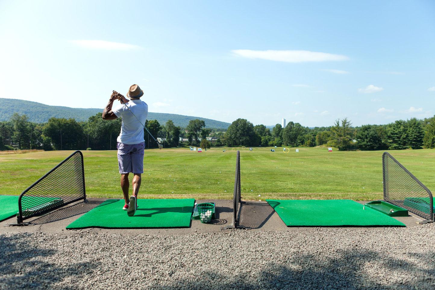 A student practicing in a Golf Driving Range