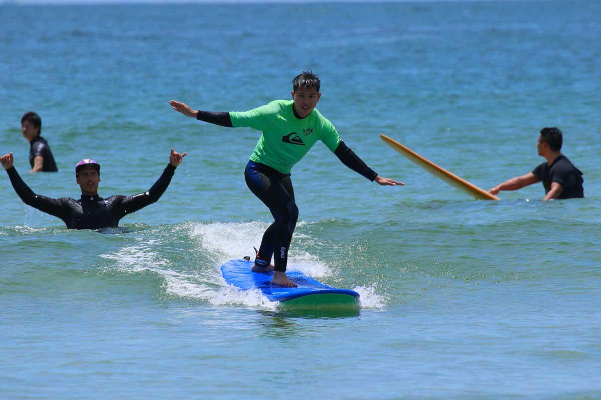 kid in his surf lesson riding a wave