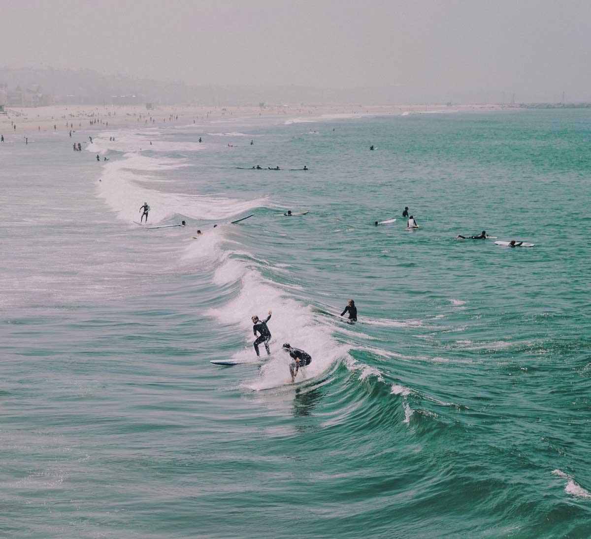 group of people taking a surf lesson in los angeles
